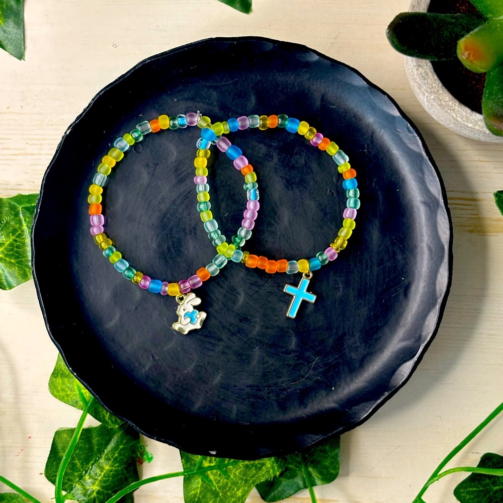Handmade bead bracelets with a random charm, cross or bunny